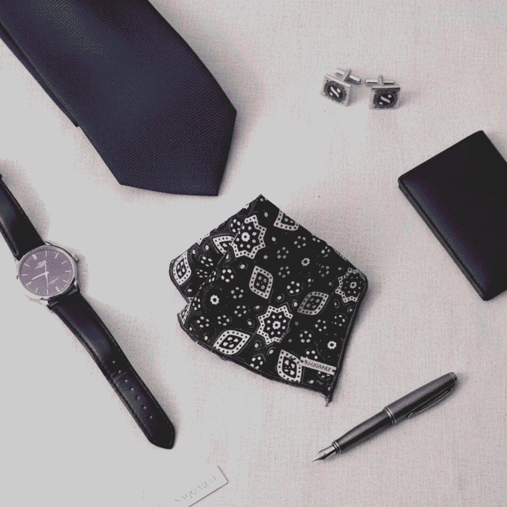 This is fashion accessories image but focued on our product ajrak pocket square along with others like tie, pen, watch, cuff lings